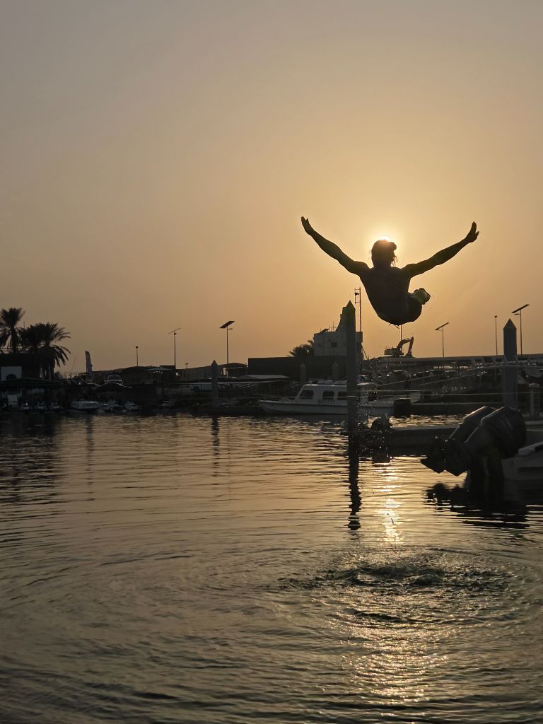 Waterline slacklining at golden hour in Jumeirah Dubai